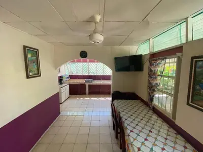 a room with a couch in a room with a kitchen at Coco verde in Coco