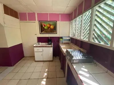 a room with a counter and a painting of apples on the wall at Coco verde in Coco