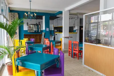 a restaurant with colorful tables and chairs at Hotel Las Colinas in Fortuna
