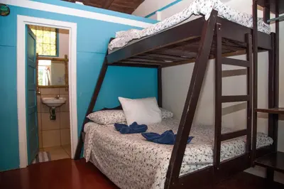 a bedroom with a bunk bed with a ladder at Hotel Brasilito in Brasilito