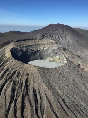 an aerial view of a crater in a desert field at Blue River Resort & Hot Springs in Liberia
