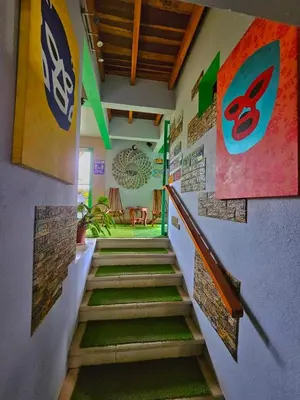 a hallway with stairs and signs on the wall at BellaVista Suites By Villas Verdes - Samara Beach in Sámara