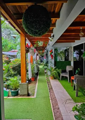 an outdoor patio with green grass and plants at BellaVista Suites By Villas Verdes - Samara Beach in Sámara