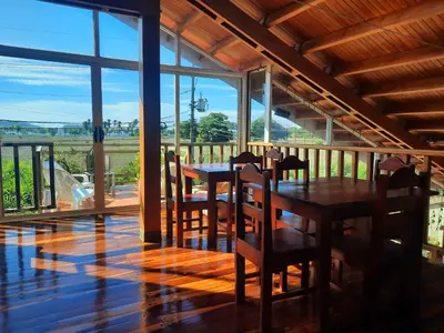 a dining room with a table and chairs on a balcony at BellaVista Suites By Villas Verdes - Samara Beach in Sámara