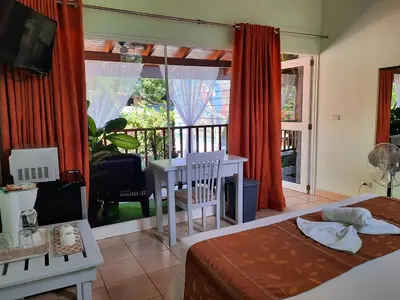 a bedroom with a bed and a balcony at BellaVista Suites By Villas Verdes - Samara Beach in Sámara