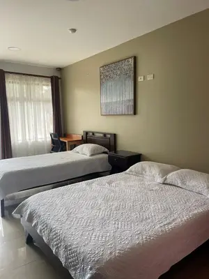 a hotel room with two beds and a table at Hotel Mi Linda Tierra in Quesada