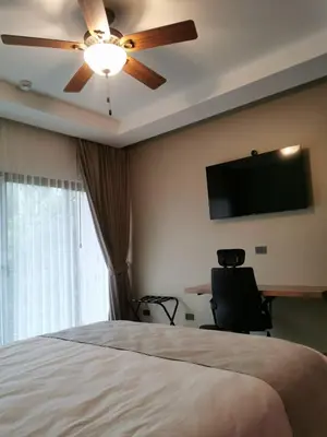 a bedroom with a ceiling fan and a tv on the wall at Hotel Mi Linda Tierra in Quesada