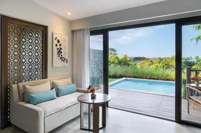 a living room with a couch and a pool at Secrets Papagayo All Inclusive - Adults Only in Papagayo, Guanacaste
