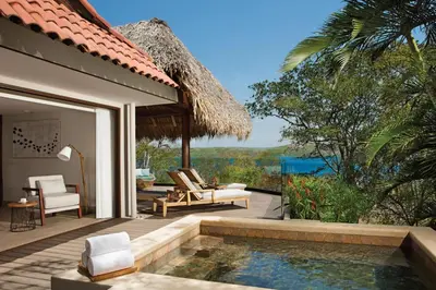 a villa with a swimming pool and a patio at Secrets Papagayo All Inclusive - Adults Only in Papagayo, Guanacaste