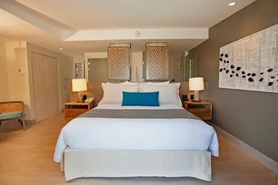 a bedroom with a large white bed and two lamps at Secrets Papagayo All Inclusive - Adults Only in Papagayo, Guanacaste