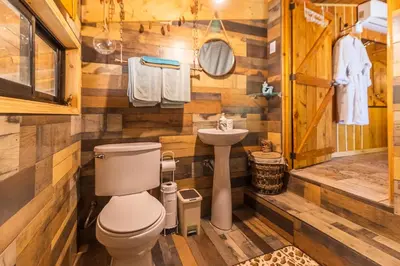 a bathroom with a toilet and a sink at Villas Wanderlust in Puntarenas