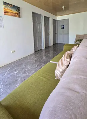 a row of beds in a room with water on the floor at Hostel Cattleya - Monteverde, Costa Rica in Monteverde Costa Rica