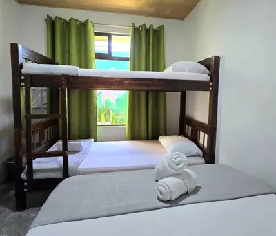 two bunk beds in a room with a window at Hostel Cattleya - Monteverde, Costa Rica in Monteverde Costa Rica
