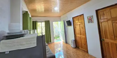 a kitchen with a wooden ceiling and a door at Hostel Cattleya - Monteverde, Costa Rica in Monteverde Costa Rica