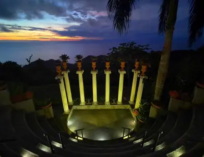 a group of stairs with a sunset in the background at Hotel Villa Caletas in Jacó