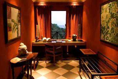 a dining room with a table and a window at Hotel Villa Caletas in Jacó