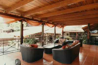 a patio with couches and chairs on a roof at El Rodeo Estancia Boutique Hotel & Steakhouse in San José