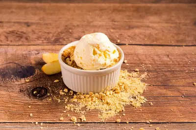 a bowl of ice cream on a wooden table at El Rodeo Estancia Boutique Hotel & Steakhouse in San José