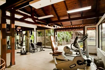 a gym with treadmills and elliptical machines at El Rodeo Estancia Boutique Hotel & Steakhouse in San José