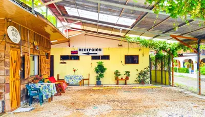 a patio of a building with tables and chairs at Cabinas Coco Alegre in Coco