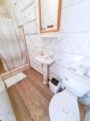 a bathroom with a toilet and a sink at Cabinas Coco Alegre in Coco