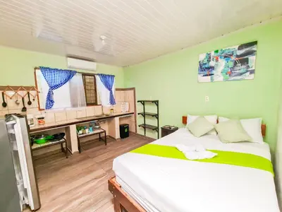 a bedroom with a bed and a desk in it at Cabinas Coco Alegre in Coco