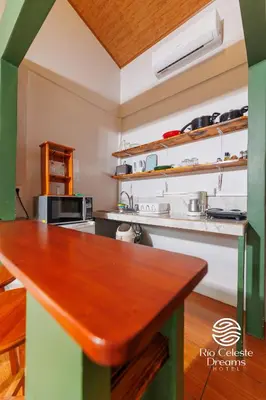 a kitchen with a wooden table in a room at Rio Celeste Dreams in Bijagua