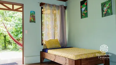 a bed in a room with a window at Rio Celeste Dreams in Bijagua
