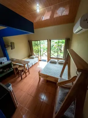 a room with a bed and a desk in a room at Rio Celeste Dreams in Bijagua