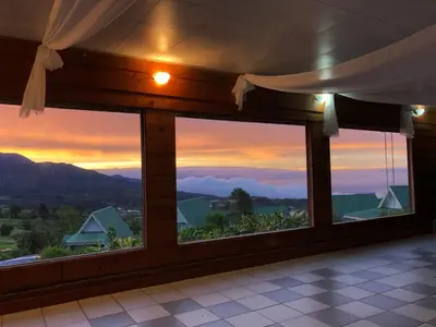 a room with windows with a view of the mountains at Hortensias Chalets Vara blanca in Heredia