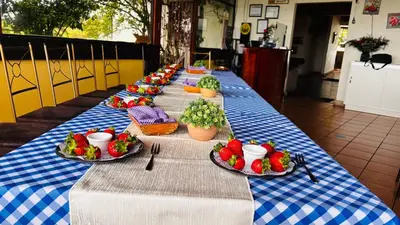 a long table with plates of food on it at Hortensias Chalets Vara blanca in Heredia