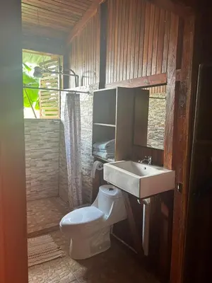 a bathroom with a toilet and a sink at Casa Torre Eco- Lodge in Fortuna