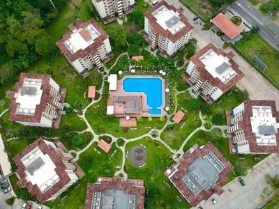 an overhead view of a yard with houses and a pool at Jaco Beach Penthouse in Jacó