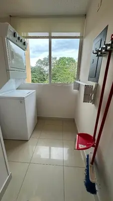 a small bathroom with a sink and a window at Jaco Beach Penthouse in Jacó