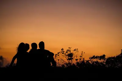 a group of people sitting on a hill at sunset at Vida Mountain Resort & Spa Adults Only in San Ramón