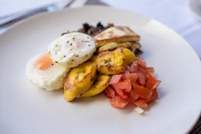a plate of breakfast food with eggs and vegetables at Vida Mountain Resort & Spa Adults Only in San Ramón