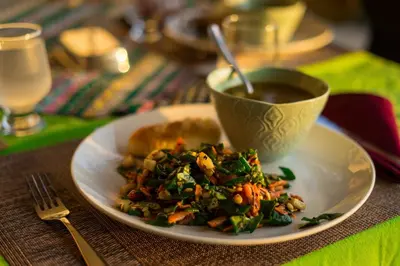 a plate of food with a bowl of soup on a table at Vida Mountain Resort & Spa Adults Only in San Ramón
