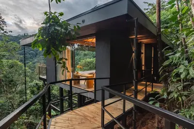 a house in theforest with a view of a deck at Rancho Pacifico - Boutique Hotel for Adults in Uvita