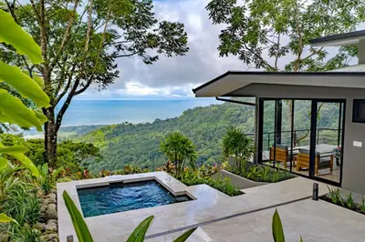 a pool in the backyard of a house with a view at Rancho Pacifico - Boutique Hotel for Adults in Uvita