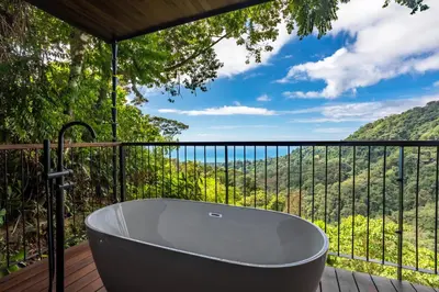 a bath tub on a deck with a view at Rancho Pacifico - Boutique Hotel for Adults in Uvita