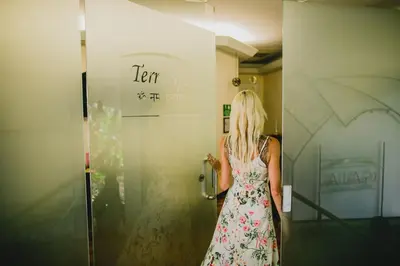 a woman standing in front of a door at Gaia Hotel & Reserve- Adults Only in Manuel Antonio