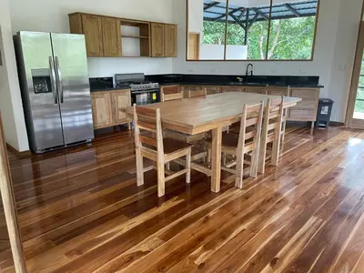 a kitchen with a wooden table and a refrigerator at Cascada Elysiana in Platanillo
