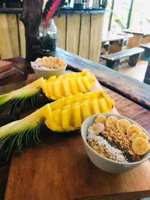 a wooden table with a bowl of food on a table at Cascada Elysiana in Platanillo