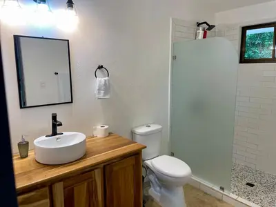 a bathroom with a sink and a toilet at Cascada Elysiana in Platanillo