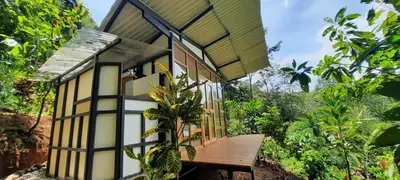 a small house with a wooden bench in front of it at Cascada Elysiana in Platanillo