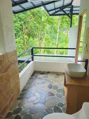 a bathroom with a tub and a sink on a balcony at Cascada Elysiana in Platanillo