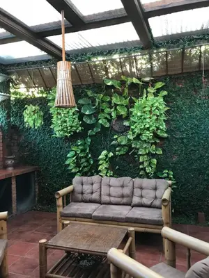 a living wall with a couch on a patio at Ruiselares in Puntarenas