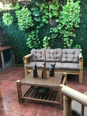 a couch with two umbrellas sitting on a table at Ruiselares in Puntarenas