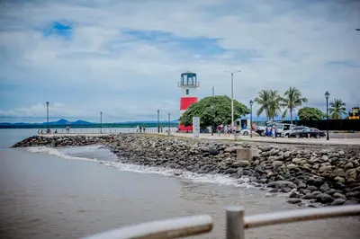 a lighthouse with a red and white lighthouse at Hotel Yadran Beach Resort in Puntarenas