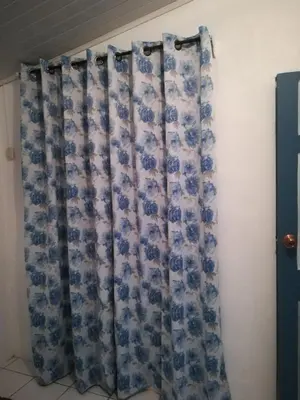 a curtain in a room next to a wall at Belis in Alajuela City